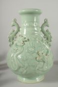 A LARGE CHINESE CELADON GLAZE TWIN HANDLE VASE, with moulded relief dragons, mark to base, 39cm