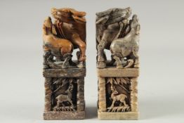 A LARGE PAIR OF CHINESE CARVED BUFFALO SOAPSTONE SEALS, 20cm high.