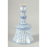 AN OTTOMAN TURKISH BLUE AND WHITE GLAZED POTTERY CANDLESTICK STAND, 26.5cm high.