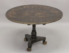 A CHINOISERIE BLACK AND GILT LACQUER CIRCULAR TOP TABLE, painted with a central scene with various