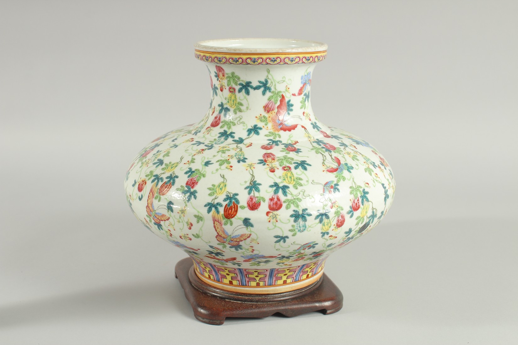 A CHINESE FAMILLE ROSE PORCELAIN SQUAT-FORM VASE and hardwood stand, the vase decorated all over - Image 3 of 6