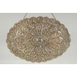 A 19TH CENTURY OTTOMAN EMBOSSED SILVER MIRROR, with relief floral decoration and hanging chain, 30.