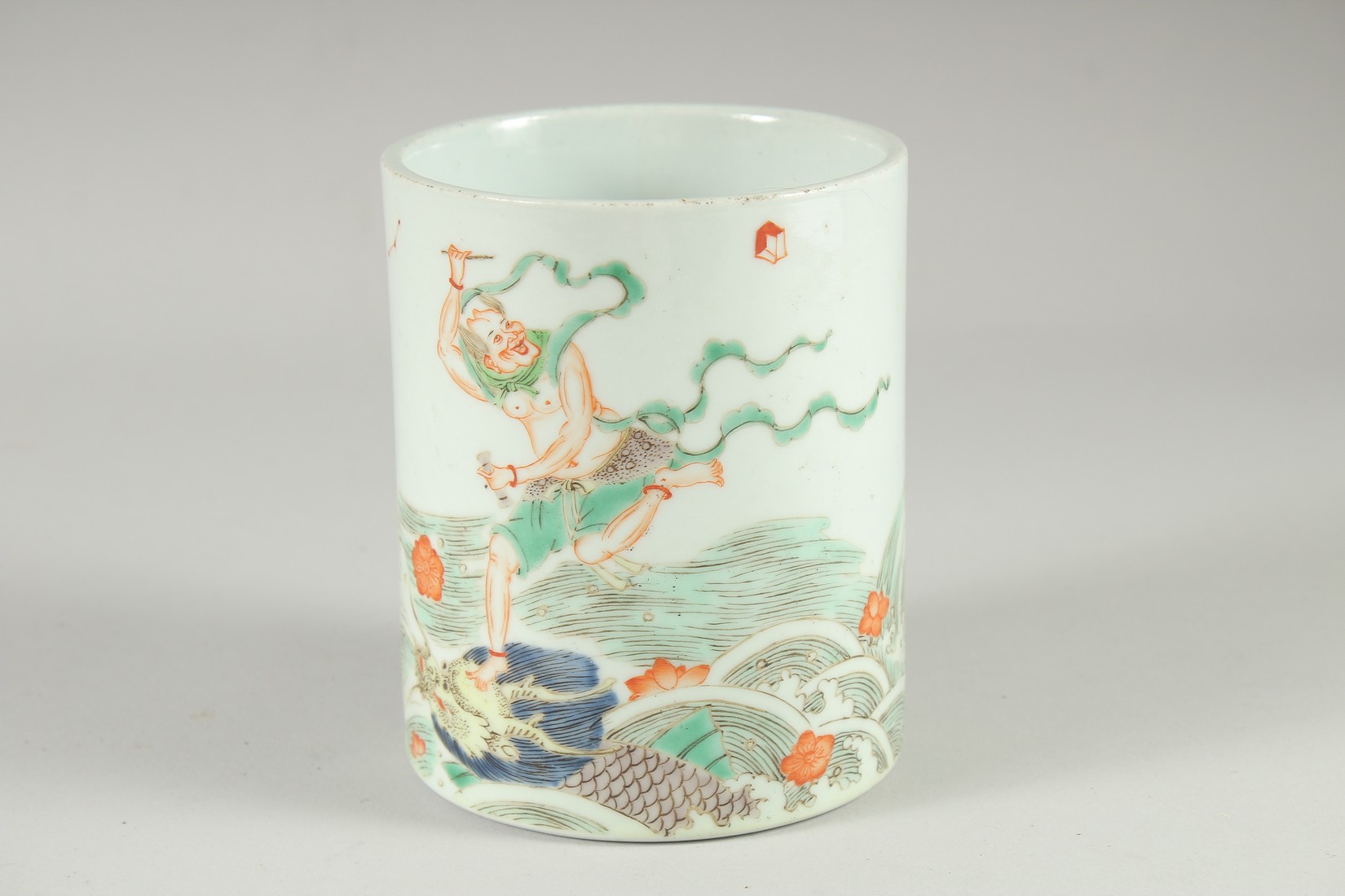 A CHINESE FAMILLE VERTE PORCELAIN BRUSH POT, painted with an immortal stood upon a dragon on