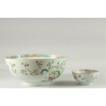 A LARGE CHINESE FAMILLE ROSE PORCELAIN PUNCH BOWL, together with a smaller famille rose bowl, (