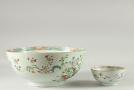 A LARGE CHINESE FAMILLE ROSE PORCELAIN PUNCH BOWL, together with a smaller famille rose bowl, (