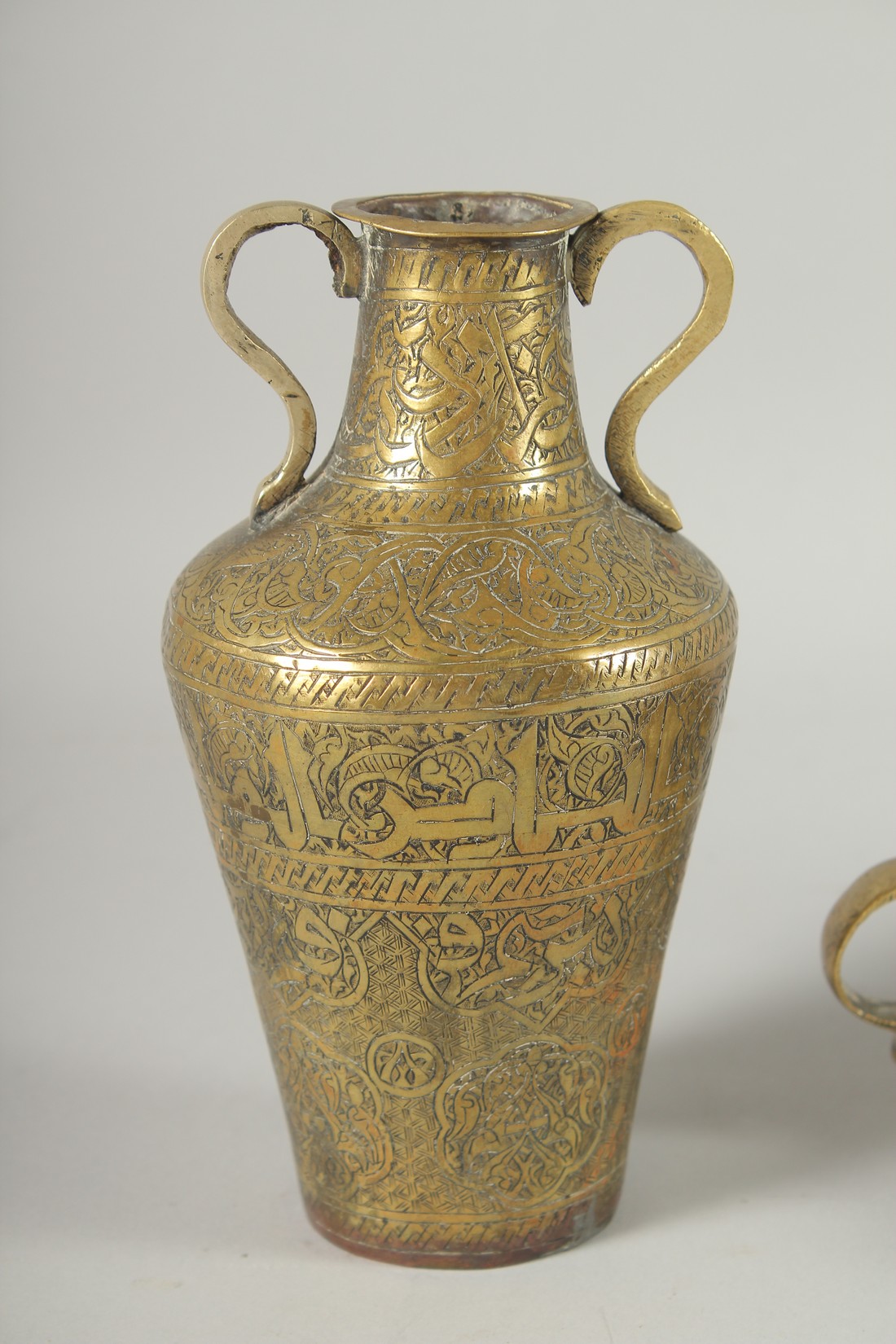 THREE 19TH CENTURY IRANIAN ENGRAVED BRASS PIECES; comprising a twin handle vase / vessel with - Image 2 of 8