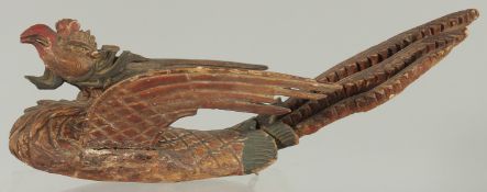 AN 18TH-19TH CENTURY SOUTH EAST ASIAN LACQUERED CARVED WOODEN PHOENIX, possibly Thai, 30cm long.
