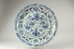 A LARGE CHINESE BLUE AND WHITE PORCELAIN DISH, decorated with a central panel of ducks and flora,