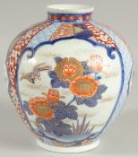 A FINE JAPANESE IMARI PORCELAIN BULBOUS VASE, beautifully painted with panels of birds and native