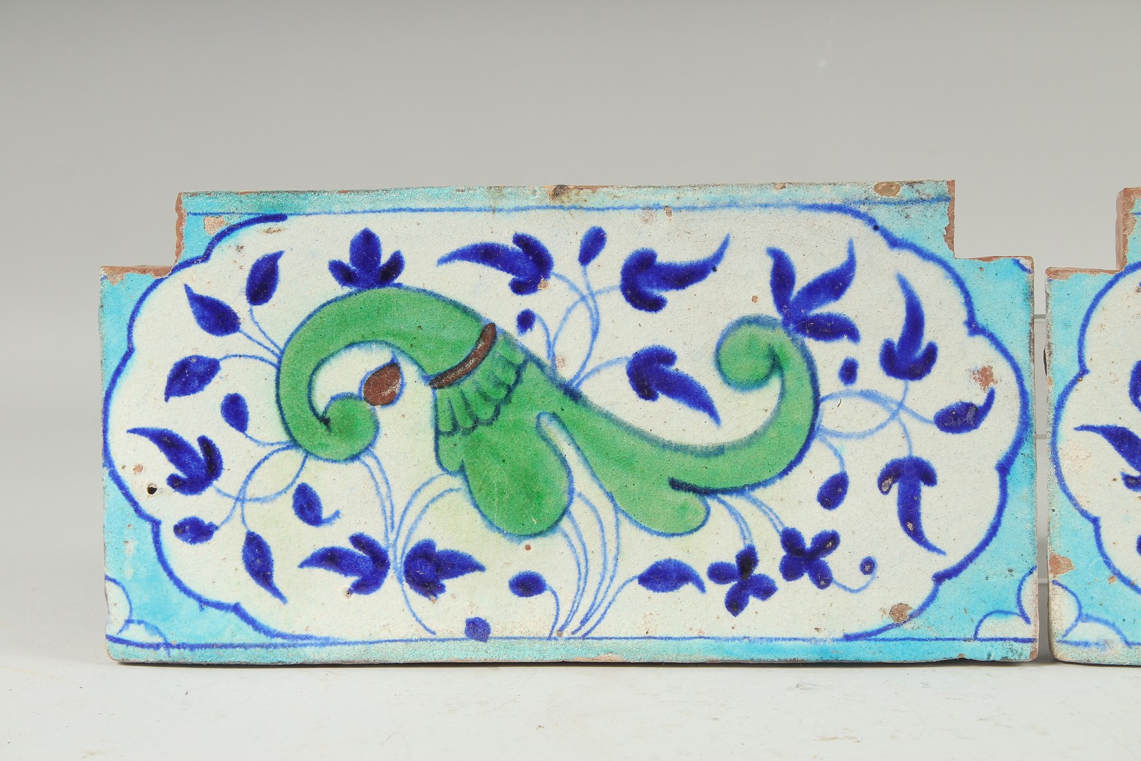 A PAIR OF 18TH-19TH CENTURY MUGHAL NORTH INDIAN MULTAN POTTERY TILES, each 30cm x 15cm. - Image 2 of 4