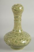 A CHINESE OLIVE GREEN GLAZE CARVED GARLIC-HEAD VASE, with panels of birds and flora, 22.5cm high.