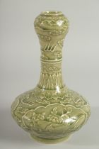 A CHINESE OLIVE GREEN GLAZE CARVED GARLIC-HEAD VASE, with panels of birds and flora, 22.5cm high.