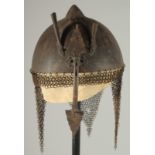 A QAJAR GOLD DAMASCENED STEEL HELMET, with retractable nose guard and chain mail neck skirt, the