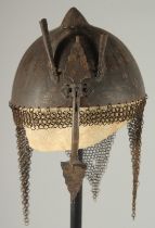 A QAJAR GOLD DAMASCENED STEEL HELMET, with retractable nose guard and chain mail neck skirt, the