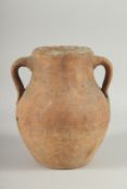 A 10TH-12TH CENTURY IRANIAN TERRACOTTA TWIN HANDLE POT, with glazed green interior, 22.5cm high.
