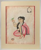 KALIGHAT SCHOOL BENGAL PAINTING ON PAPER OF A LADY WITH BIRD, with mount and mount board surround;