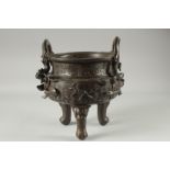 A LARGE CHINESE BRONZE TWIN HANDLE TRIPOD CENSER, with relief horses and sea creatures, the