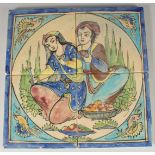 A SET OF FOUR GLAZED POTTERY TILES, together painted with a seated male and female with bird