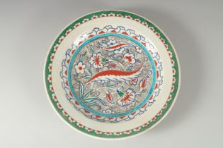 AN OTTOMAN TURKISH IZNIK GLAZED POTTERY PLATE, 31cm diameter.