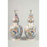 A GOOD PAIR OF DELFT BULBOUS VASES with reverse panels of birch and flowers. 17ins high.