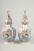 A GOOD PAIR OF DELFT BULBOUS VASES with reverse panels of birch and flowers. 17ins high.