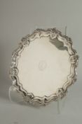 A GOOD SILVER PIE CRUST SALVER with scroll and floral border. 12ins diameter. Sheffield, 1904.
