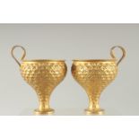 A PAIR OF LALAOUNIS SILVER GILT GOBLETS.