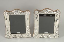 A PAIR OF SILVER PHOTOGRAPH FRAMES. 7.5ins x 5ins
