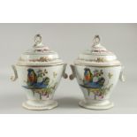 A GOOD PAIR OF SEVRES DESIGN WHTIE GROUND ICE PAILS AND COVERS decorated with birds. 9ins high.