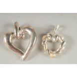 TWO SILVER HEART SHAPED PENDANTS.