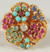 AN 18 CT GOLD TURQUOISE, RUBY, EMERALD, SAPPHIRE AND DIAMOND RING.