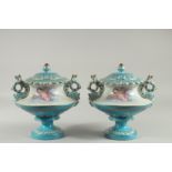 A PAIR OF SEVRES DESIGN LIGHT BLUE CIRCULAR PEDESTAL VASES decorated with cupids. 10ins high.