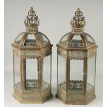 A PAIR OF CROWN TOP METAL HANGING OCTAGONAL LANTERNS.