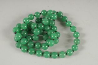 A STRING OF JADE BEADS. 26ins long.