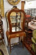 A GOOD FRENCH KINGWOOD ORMOLU MOUNTED VITRINE with mirrored backs, glass door and sides on curving