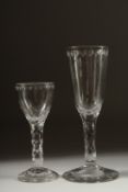 TWO GEORGIAN GLASSES both with facet cut stems. 6.5ins & 5ins high. (2).