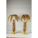 A PAIR OF GILT METAL PALM TREE LAMPS. 26ins high.