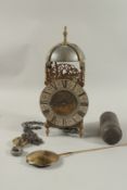 AN 18TH CENTURY BRASS LANTERN CLOCK with bell hood and fusee movement. 14ins high with chain, weight