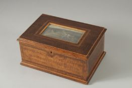 A 19TH CENTURY MAHOGANY JEWEL BOX, the lid with a painting of a country house. 10ins long.