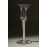 A GEORGIAN WINE GLASS with inverted bell shape bowl and white twist stem. 6ins high.