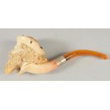 A MEERSCHAUM PIPE CARVED AS A MAN'S HEAD with a long beard and plumed hat. 8cm long, 7cm deep with