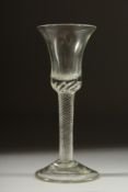 A GEORGIAN GLASS with inverted plain bowl and air twist stem. 6.5ins high.