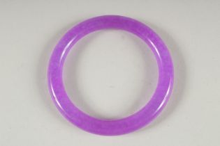 A LAVENDER JADE BANGLE. 3ins diameter.