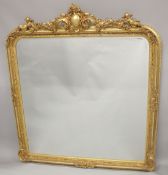 A LARGE GILTWOOD OVER MANTLE MIRROR with scrolls and cupids. 5ft 6ins high, 4ft 8ins wide