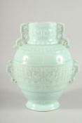 A CHINESE PALE TURQUOISE GROUND VASE with pierced handles and moulded decoration. 11ins high