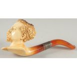 A MEERSCHAUM PIPE carved as a Negro head. 7cm long 6cm deep with silver band and amber mouthpiece,