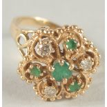 A 14CT GOLD DIAMOND AND EMERALD CLUSTER RING