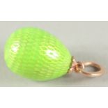 A 14CT GOLD RUSSIAN GREEN EGG PENDANT with a snake.