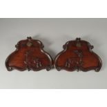 A GOOD PAIR OF FINELY CARVED PANELS with stags. 10.5ins wide.