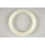 A WHITE JADE TWIST BANGLE 3.25ins diameter.